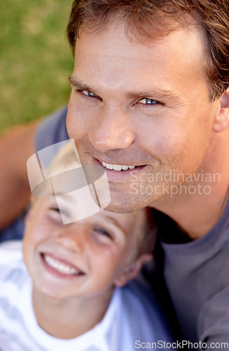 Image of Portrait, happy man and son sitting on grass, cute bonding together with care and love from above. Fun, father and child on ground in backyard of home with smile, trust and support with dad and boy.