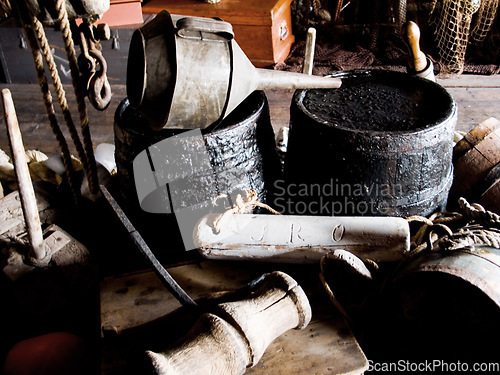 Image of Interior, cabin and vintage tools, equipment and relics, barrels and bellows for storage of gear. Retro room, rustic cottage and old rope, wood and hammer in house, home and architecture in shack