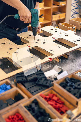 Image of Man is working with electric screwdriver