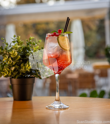 Image of Tall glass with a refreshing red cocktail