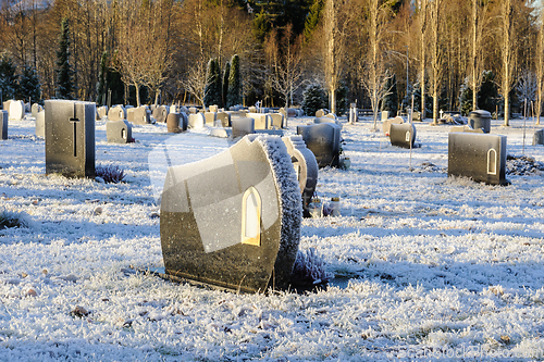 Image of frozen graveyard with tombstones in sunlight