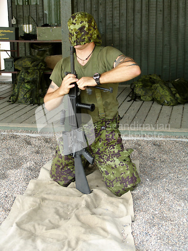 Image of Army, training to assemble a gun with a man soldier outdoor in camouflage uniform for an exercise. Military, blindfold and a trooper person at bootcamp to build a weapon or rifle in record time