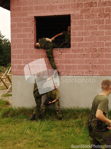 Image of Soldier, climbing and team with training outdoor for fitness, exercise or challenge in nature with gear. Military, people and obstacle for workout, mission or bootcamp with camouflage for survival