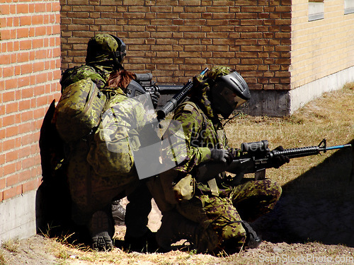 Image of Mission, soldier and target by building with weapon for fitness, exercise or challenge outdoor with gear. Military, people and battle for workout, attack or bootcamp with camouflage for survival