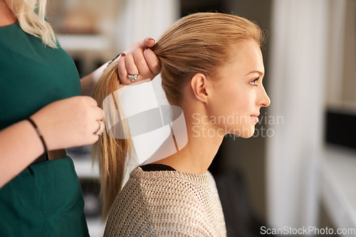 Image of Hairdresser, beauty and woman styling for long, healthy and long hairstyle on a young model. Stylist, ponytail and beautiful female person from Australia at salon or spa for self care treatment.