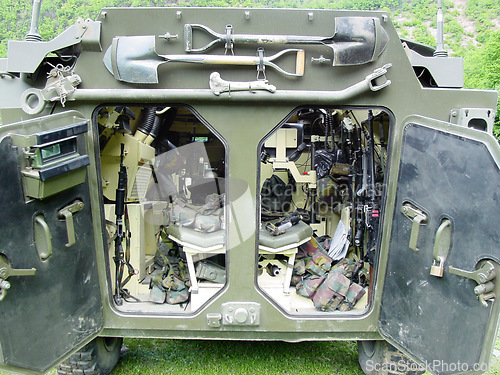 Image of Inside, military vehicle and tools for army with gun, shovel or storage of equipment in tank. Combat, tanker and collection of supplies, guns or tactical gear for mission, war or training operation