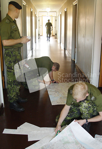 Image of Army, war and map with a soldier team planning a battle strategy in the hallway of their military base. Training, teamwork and camouflage with personnel getting ready for problem solving in uniform