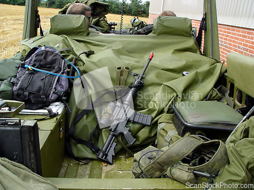 Image of Soldiers, vehicle and military equipment for mission, objective or outdoor hunt with gun, ammunition or storage. People or army at base with truck for firearm, rifle or supplies ready for rendezvous