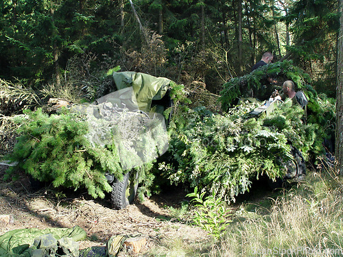 Image of Forest, war and a military vehicle in camouflage for an attack or ambush during a special forces mission. Nature, army and a car covered in grass in the countryside for training as a soldier