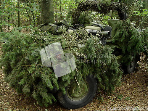 Image of Forest, war and an army vehicle in camouflage for an attack or ambush during a special forces mission. Nature, military and a car covered in grass in the countryside for training as a soldier