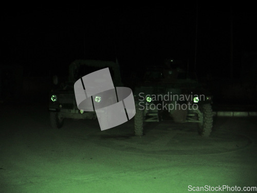 Image of Night vision, military and vehicle in dark for army battle, target or enemy scan on battlefield or camp. Cars, transport and armed forces for attack, operation or armor outdoor with patrol or defense