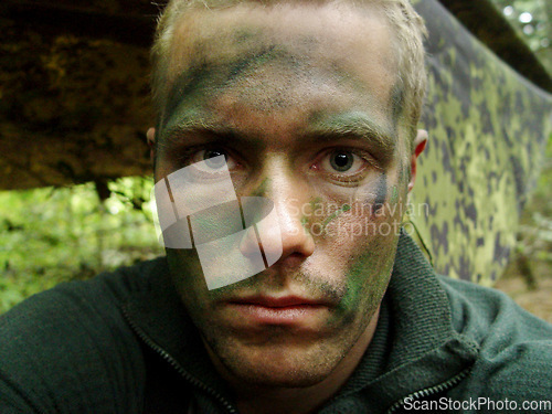 Image of Military, man and portrait of soldier with paint for camouflage, mission or incognito at ukraine war, or service. Battle, face and person at bootcamp or battlefield for operation, protection or war