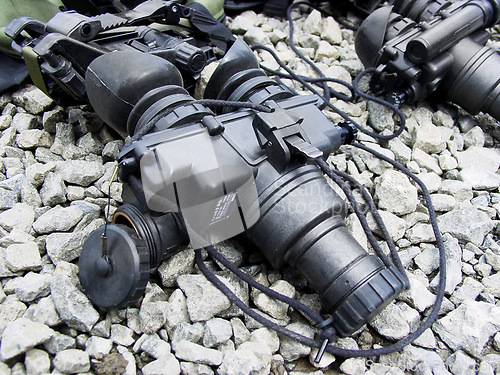 Image of Night vision goggles, military equipment and surveillance from above for combat training or mission. War, army gadget or glasses for a tactical stealth operation closeup on the ground with stones