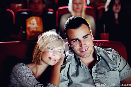 Image of Cinema, relax and happy couple watching film or show on romantic date together in evening. Movie night, man and woman in theater hall with smile, sleep and sitting in auditorium to relax at premier