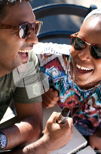 Image of Happy, laugh and friends with beer at an outdoor cafe relax, bond and hanging out on the weekend. Funny, joke and people sharing comedy, gossip and alcohol outside at restaurant with vacation freedom