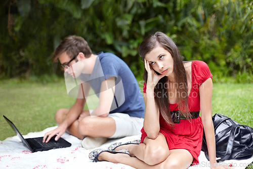 Image of Couple, conflict and frustrated woman on disaster picnic date with distracted man on laptop in forest. Crisis, fail and annoyed female with workaholic male in park online with social media addiction