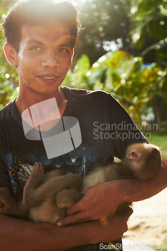 Image of Zoo, nature and portrait of man with monkey for care, conservation and wildlife rescue. Sanctuary, travel and happy person with macaque in environment, ecosystem and animal park for Thailand tourism