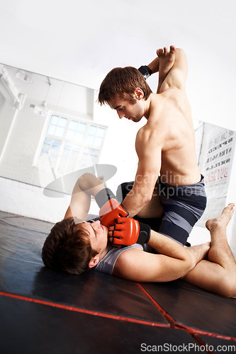 Image of Martial arts, competition and men fight in gym, training and fitness with power, strong and kickboxing for sport. Exercise, workout and athlete in dojo, MMA and contest with boxer, action and muscle