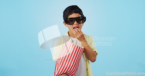 Image of Popcorn, 3d or child in studio for a movie, watching tv or VR film on blue background with snack. Future technology, virtual reality experience or kid eating food for 3d cinema or metaverse show