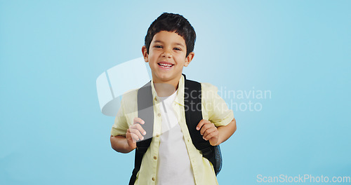Image of School, happy or face of child in studio on blue background ready for class, learning and education. Student, smile or portrait of a young boy with bag excited for lesson, academy or kindergarten