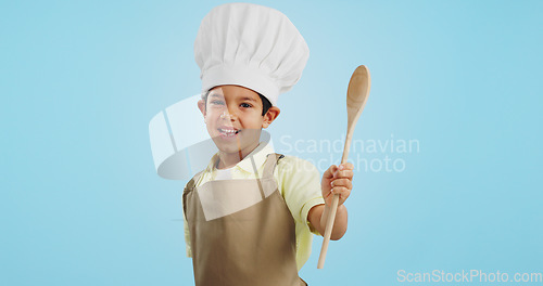 Image of Happy, face and child with a spoon for baking, young chef or getting ready for the kitchen. Smile, boy kid or portrait with equipment for cooking, future career or preparation on a studio background