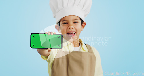 Image of Chef kid, face or phone green screen in studio for social media, cooking tutorial ads or download. Blue background, space or happy child with notification for online marketing, mockup or advertising