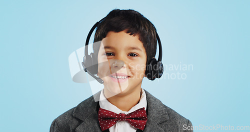 Image of Face, studio or child consultant in call center talking or networking for telecom on blue background. Young, contact or friendly kid sales agent in communication or conversation at customer service