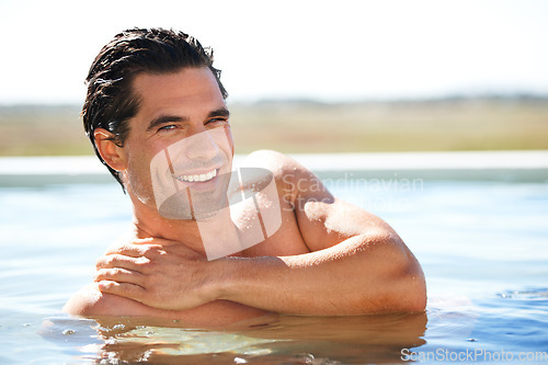 Image of Infinity pool, portrait and happy man swimming outdoor for travel, freedom or summer holiday at resort. Relax, smile and face of male swimmer in nature for luxury getaway at villa, spa or hotel trip