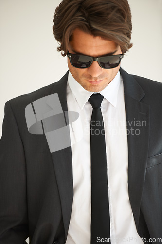 Image of Business, attitude and confident man in office with glasses, attitude or empowered on wall background. Leader, mindset and cool male entrepreneur thinking, edgy and posing with leadership or focus