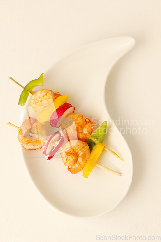 Image of Prawn, kebab and food on plate with shrimp, vegetables and luxury menu, meat or fine dining mockup. Grilled, seafood and creative presentation of gourmet appetizer on skewers in restaurant or studio
