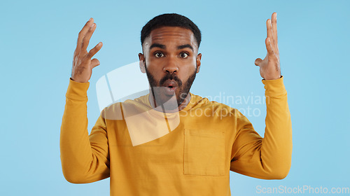 Image of Wow, face and man with mind blowing news in studio with shocked, gesture or expression on blue background. Surprise, portrait and male model with hand emoji for unexpected deal, announcement or info