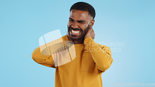 Image of Neck pain, stress and man in studio frustrated with arthritis, tension or pressure on blue background. Shoulder, anxiety and face upset male model with burnout, osteoporosis or fibromyalgia injury