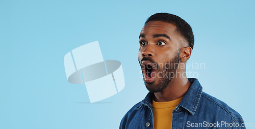 Image of Black man, surprise announcement and shock on face, expression and drama on blue background. Wow, reaction to news and alarm in studio with gossip, alert and mockup space with mind blown in studio