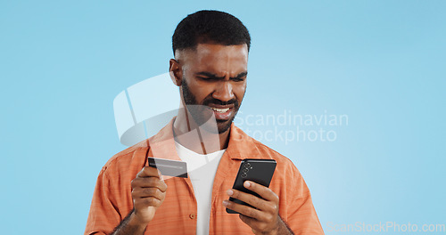 Image of Man, credit card and confused with phone, studio and thinking of price, code or info by blue background. Online shopping, payment glitch or mistake with declined account with fintech with smartphone