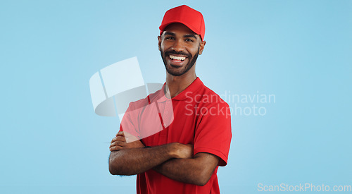 Image of Delivery man, arms crossed in portrait and e commerce, distribution with supplier and service on blue background. Professional, supply chain and logistics worker for shipping and courier in studio