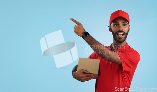 Image of Advertising studio smile, delivery man and point at supply chain commercial, discount export info or distribution schedule. Courier service deal, mockup space and portrait person on blue background