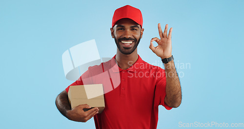 Image of Delivery man, box and okay hands for success, product excellence and courier services in studio. Happy face of supply chain worker or african person for package or distribution on blue background