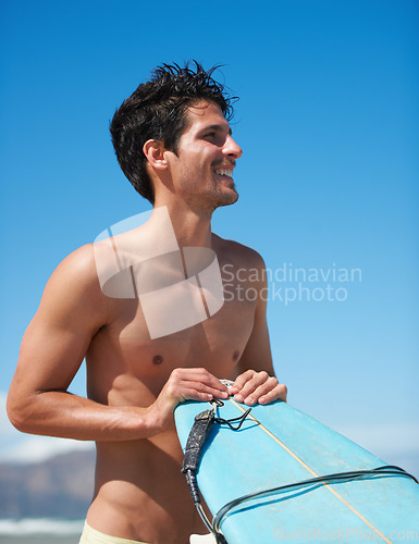 Image of Surfing, fitness and body happy man at a beach with surfboard for training, freedom or fun. Smile, adventure and male surfer at the sea for water sports, travel or vacation, holiday or summer hobby