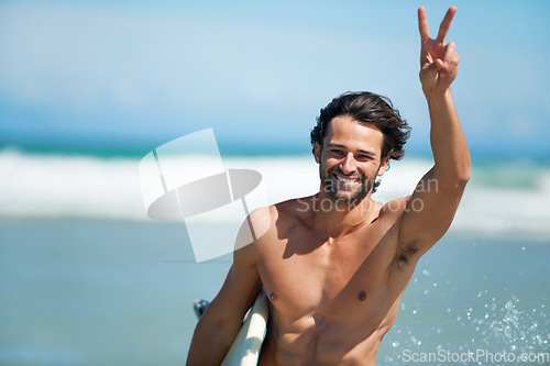 Image of Surfing, portrait and happy man with peace hands at a beach for travel, freedom or adventure. Face, smile and male surfer with v sign at sea for water sports, training or summer vacation in Miami