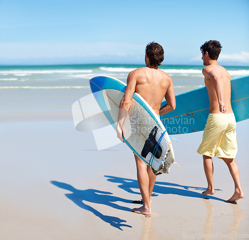 Image of Surfer, running and rear view of men friends at a beach with freedom, energy or fun. Back, fitness and surfing people at the ocean excited for summer vacation, workout or water sports hobby in Hawaii