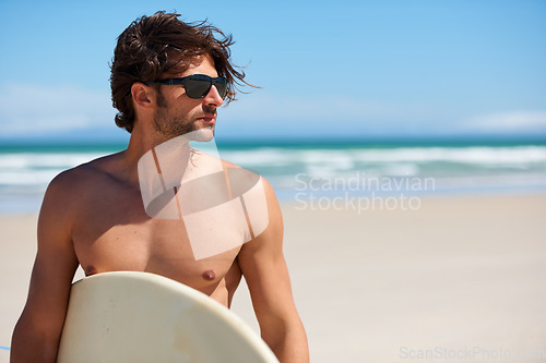 Image of Man tinking, surf and travel with sunglasses by the beach and sea for fitness and water sport with mockup space. Confidence, male person and surfboard for workout and training by ocean with freedom
