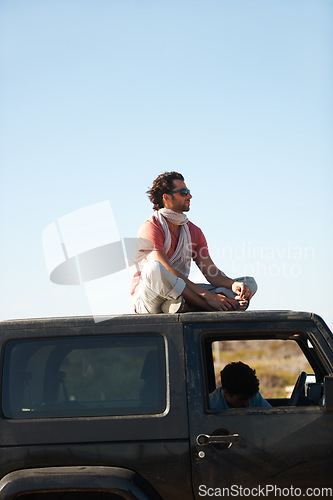 Image of Road trip, man and sitting on car roof for scenery, nature and fresh air on adventure or vacation in South Africa. People, tourist or traveler on rooftop of van with sunglasses for view or journey