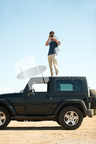 Image of Photographer, man and camera on jeep outdoor for road trip, adventure or journey on rooftop with travel. Person, photography or memories for vacation, holiday or scenery in Asia or blue sky in nature
