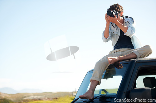 Image of Man, photographer and camera on car with sky for road trip, adventure or journey on rooftop with travel. Person, photography or memories for vacation, holiday or scenery in Asia on mock up in nature