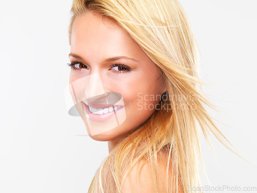 Image of Portrait, hair and smile with a natural woman in studio on a white background for luxury or keratin treatment. Face, beauty and makeup with a happy young model at the spa or salon for dermatology