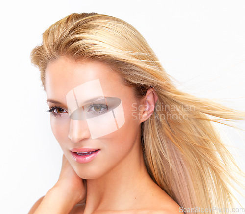Image of Face, shampoo and hair of a woman closeup in studio on a white background for natural wellness or cosmetics. Beauty, skincare and wind with a confident young model at the salon for dermatology