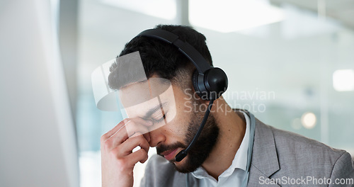 Image of Stress, headache and man in call center, tired and fatigue at help desk in office. Burnout, anxiety and sales agent in telemarketing frustrated with customer crisis, work mistake and fail challenge