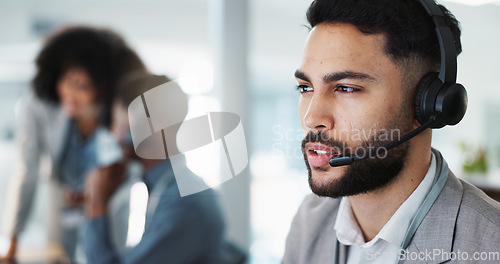 Image of Call center, face or man speaking in CRM, telemarketing or telecom office for online customer services. Microphone headset, computer or sales agent in tech support help desk for consulting or talking