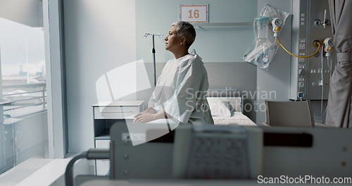 Image of Sad, patient and thinking in hospital with window and stress, anxiety or fear of cancer, death and insurance. Senior, woman and depression in clinic with lady worried for future or mental health