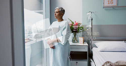 Image of Sad, patient and thinking in hospital with window and stress, anxiety or fear of cancer, death and insurance. Senior, woman and depression in clinic with lady worried for future or mental health